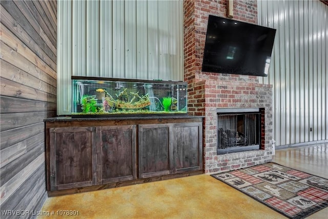 interior space with a fireplace and wooden walls