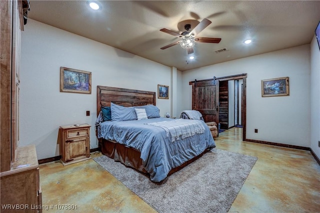 bedroom with ceiling fan and a barn door