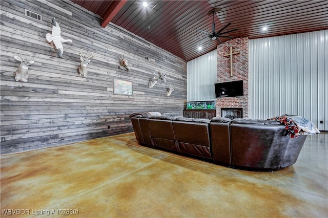 living room with lofted ceiling with beams, concrete floors, wooden ceiling, and wooden walls