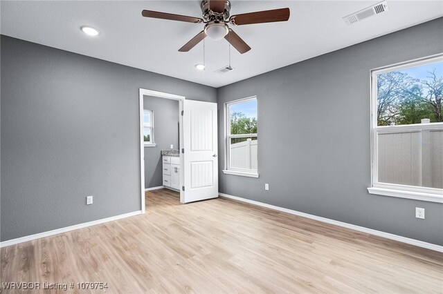 152 Maplewood Loop, Charleston, AR 72933 - unfurnished bedroom with visible vents, light wood-style flooring, baseboards, and ceiling fan