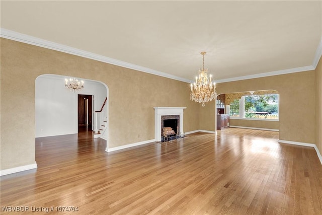 unfurnished living room with a notable chandelier, crown molding, and wood-type flooring