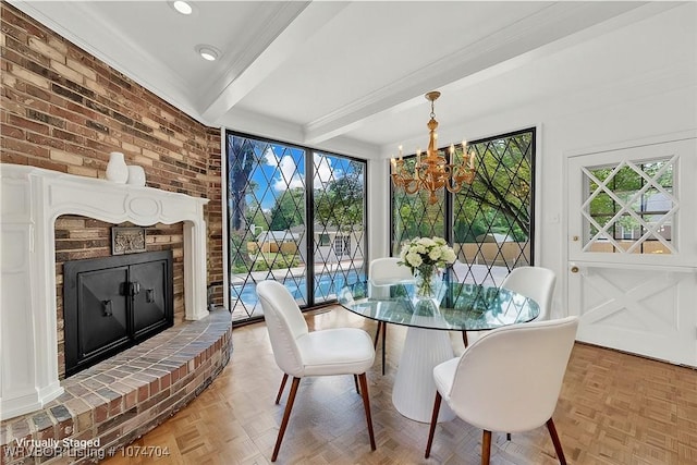 dining space with beam ceiling, a brick fireplace, a chandelier, and light parquet flooring