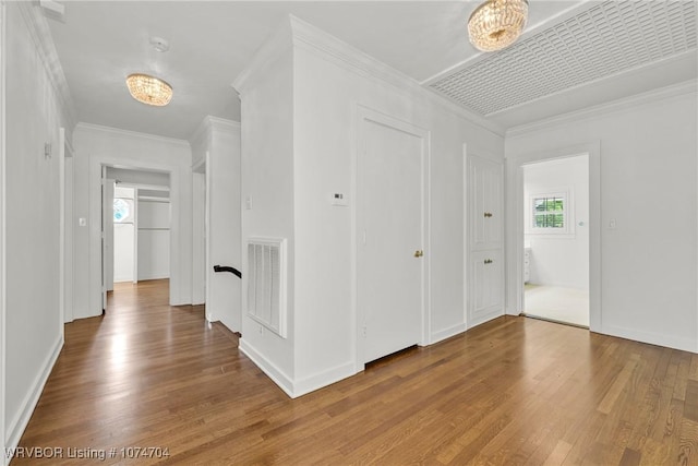 hallway featuring hardwood / wood-style flooring and crown molding