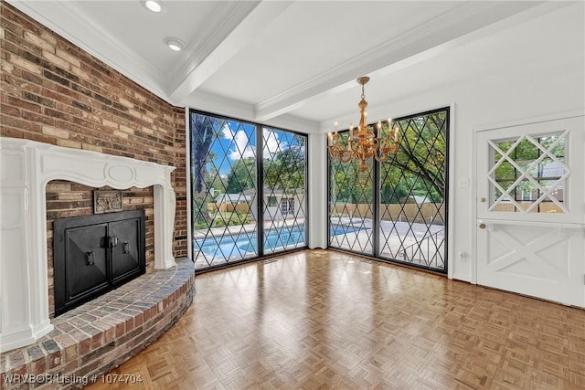 unfurnished living room featuring a fireplace, light parquet flooring, a chandelier, and beamed ceiling