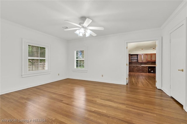 spare room featuring ornamental molding, ceiling fan, and light wood-type flooring