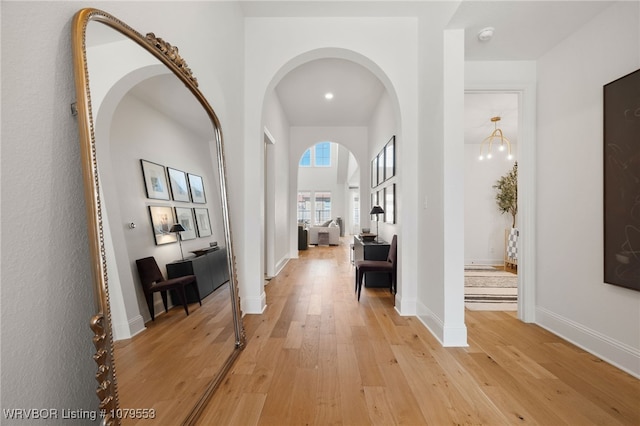 hallway with light wood-style floors and baseboards