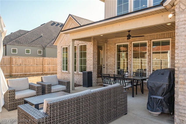 view of patio / terrace featuring a ceiling fan, a grill, fence, and an outdoor hangout area