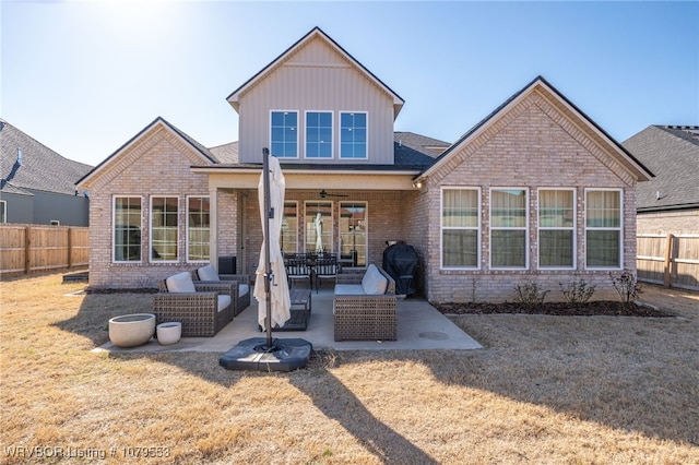 rear view of property with a patio, a fenced backyard, an outdoor hangout area, brick siding, and ceiling fan