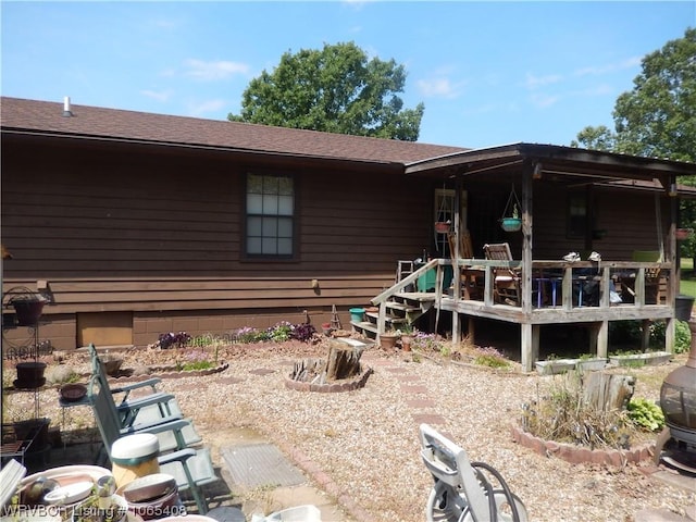 rear view of property with a wooden deck