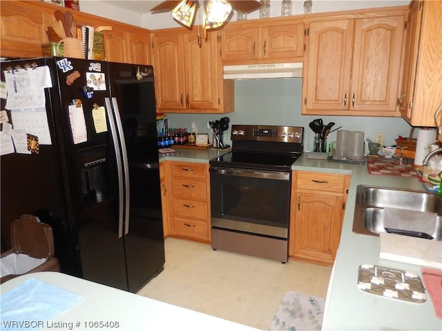 kitchen with black refrigerator with ice dispenser, sink, and stainless steel range with electric stovetop