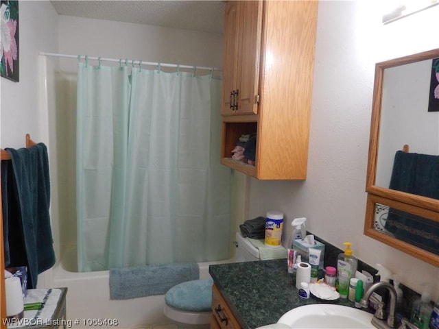 full bathroom featuring vanity, shower / bath combination with curtain, and toilet