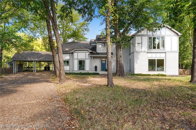 view of front of house with a front yard and a carport