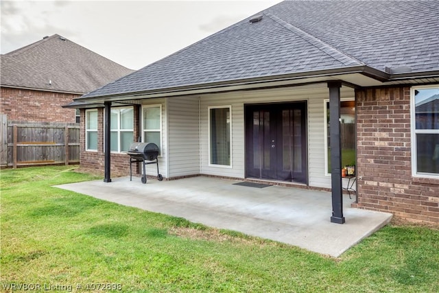 back of house featuring a patio area and a lawn