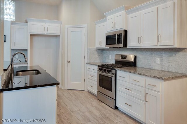 kitchen featuring white cabinetry, sink, and stainless steel appliances