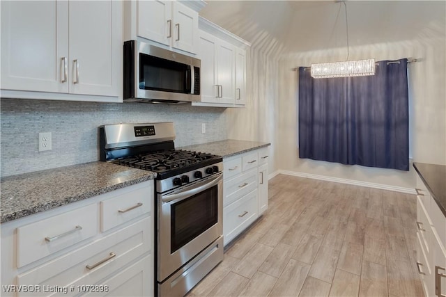 kitchen featuring light stone countertops, light hardwood / wood-style flooring, a chandelier, white cabinets, and appliances with stainless steel finishes