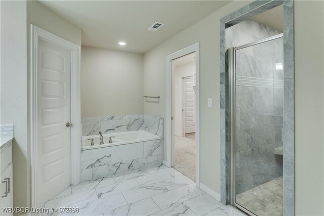 bathroom with shower with separate bathtub