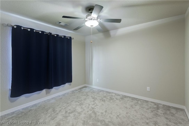 carpeted spare room with ceiling fan