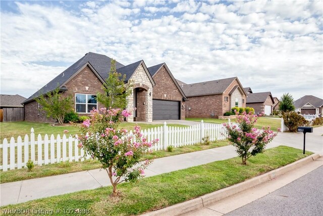 view of front of home featuring a front yard and a garage