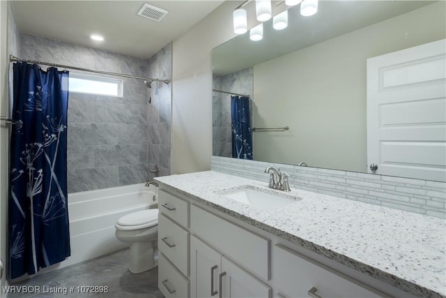 full bathroom with vanity, shower / bath combo, and toilet