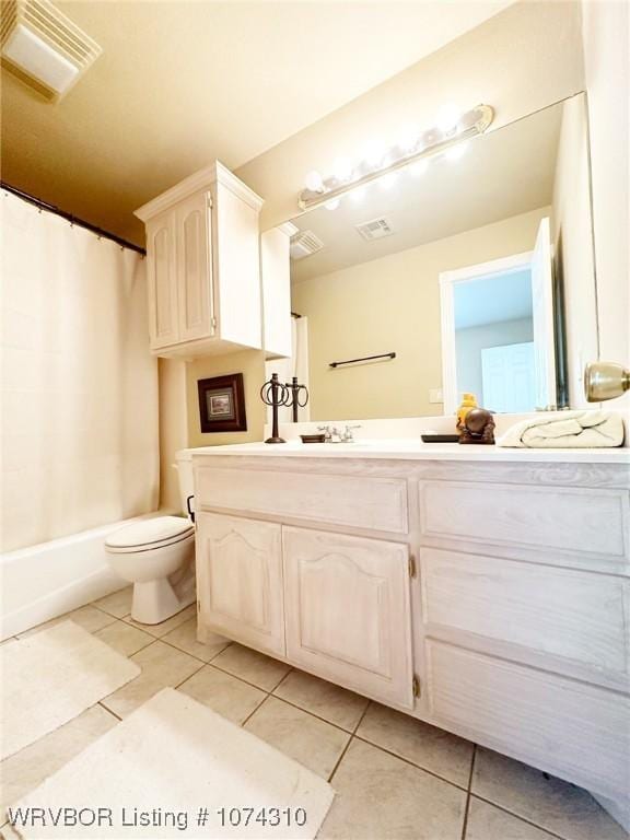 bathroom with tile patterned floors, vanity, and toilet