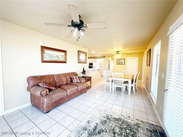 tiled living room with ceiling fan