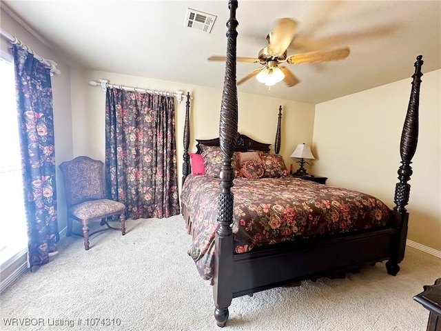 carpeted bedroom with ceiling fan and multiple windows