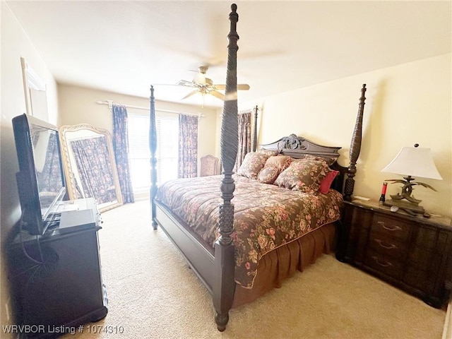 bedroom featuring ceiling fan and light carpet