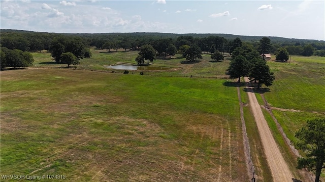 birds eye view of property featuring a water view and a rural view