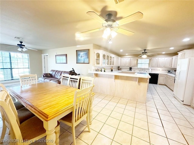 dining room with light tile patterned floors and ceiling fan