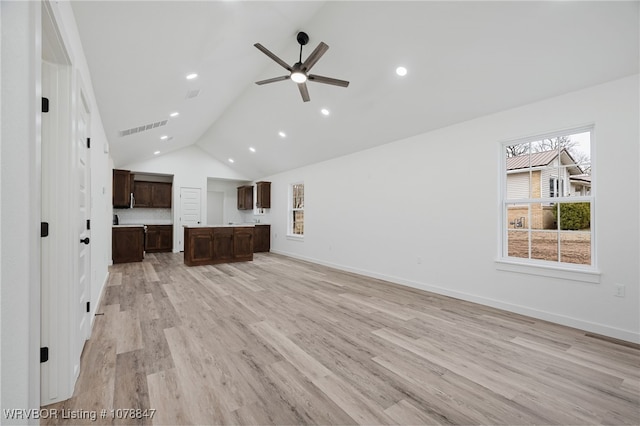 unfurnished living room featuring high vaulted ceiling, light hardwood / wood-style floors, and ceiling fan