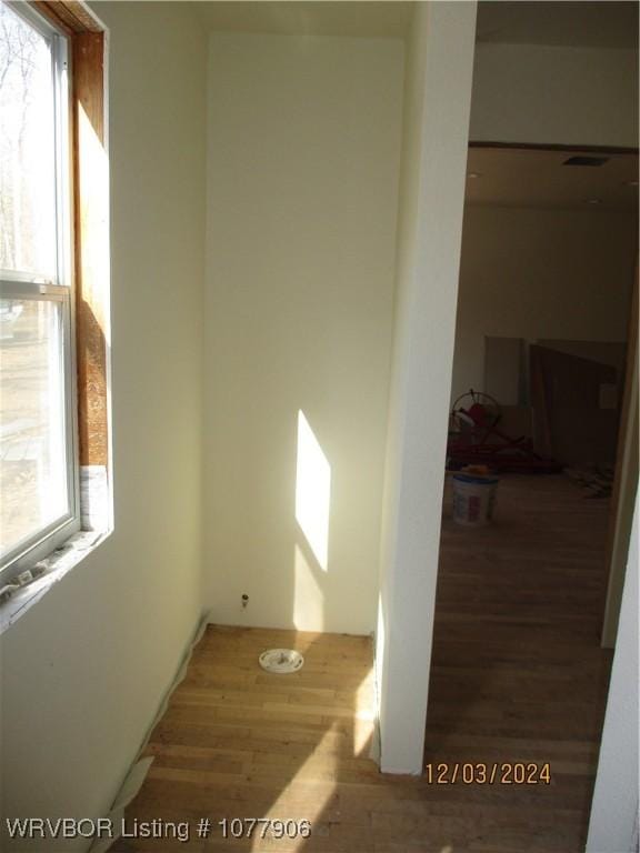 unfurnished room with hardwood / wood-style flooring