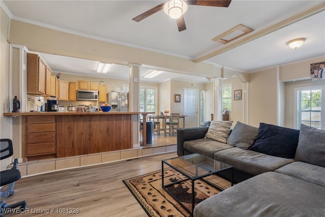 1501 S R St, Fort Smith, AR 72901 - living area featuring light wood-style flooring, plenty of natural light, ornamental molding, ceiling fan, and decorative columns