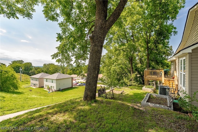 1501 S R St, Fort Smith, AR 72901 - view of grassy yard featuring a wooden deck, a vegetable garden, and cooling unit