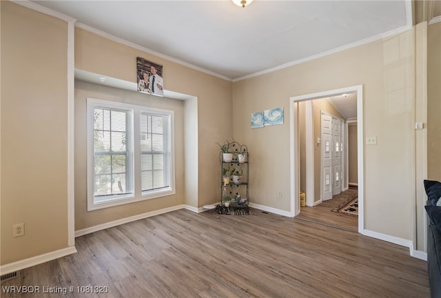 1501 S R St, Fort Smith, AR 72901 - spare room featuring wood finished floors, crown molding, and baseboards