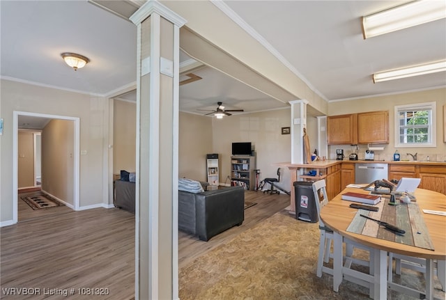 1501 S R St, Fort Smith, AR 72901 - kitchen with light wood-style flooring, dishwasher, light countertops, a sink, and crown molding