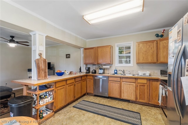 1501 S R St, Fort Smith, AR 72901 - kitchen with stainless steel appliances, ornamental molding, ceiling fan, light countertops, and a sink