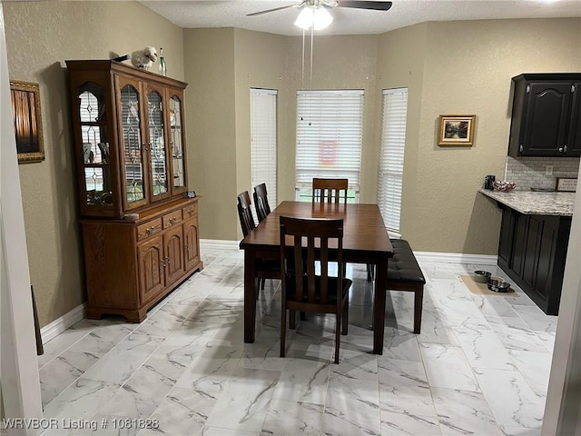 1610 Tiger Lily Ct, Greenwood, AR 72936 - dining area featuring a textured wall, ceiling fan, light marble finish flooring, and a textured ceiling