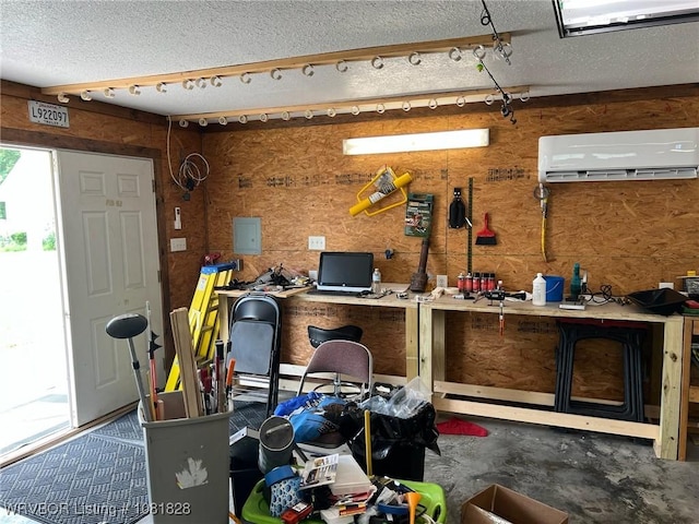 1610 Tiger Lily Ct, Greenwood, AR 72936 - misc room with a wall mounted AC, a textured ceiling, and a workshop area