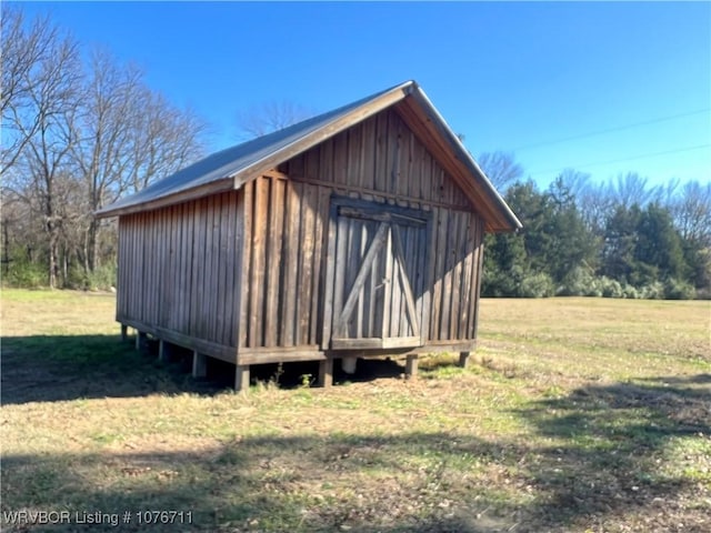 view of outbuilding with a yard