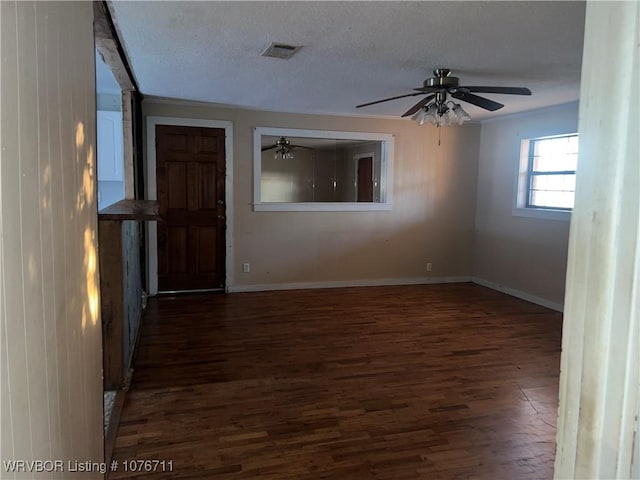 unfurnished room with ceiling fan, dark hardwood / wood-style flooring, and a textured ceiling