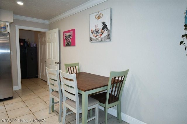 dining space with crown molding and light tile patterned floors