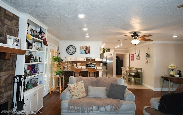 living room featuring ceiling fan, dark hardwood / wood-style flooring, a textured ceiling, and crown molding