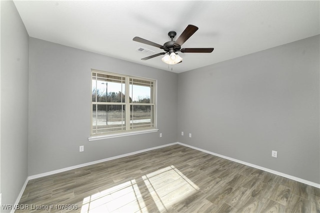 unfurnished room with ceiling fan and wood-type flooring