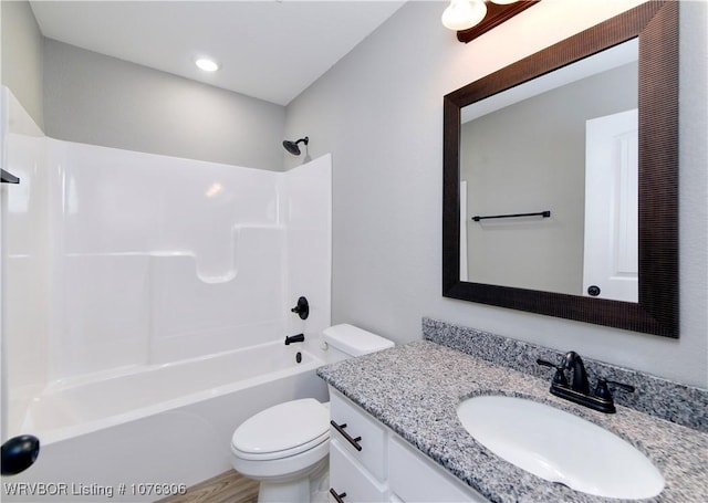 full bathroom with vanity, washtub / shower combination, and toilet