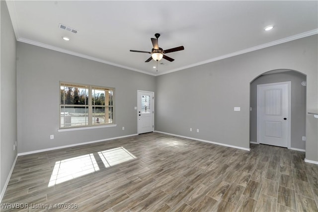 spare room with hardwood / wood-style floors, ceiling fan, and crown molding