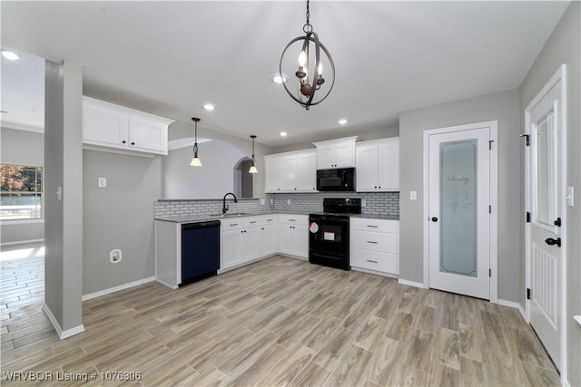 kitchen featuring backsplash, pendant lighting, white cabinets, and black appliances