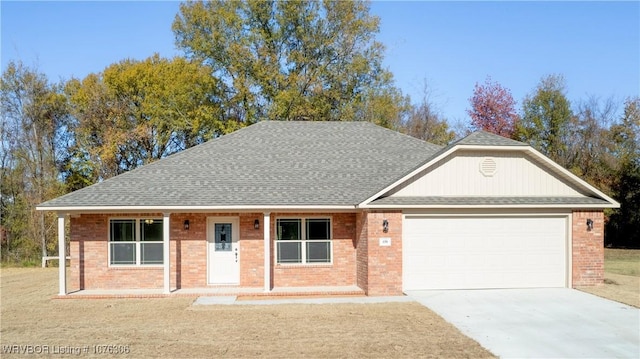 view of front of property featuring covered porch and a garage