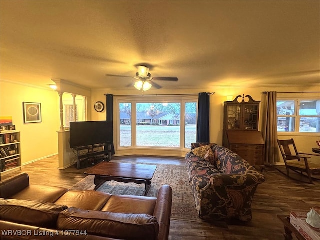 living room featuring hardwood / wood-style floors, ceiling fan, ornate columns, and a textured ceiling