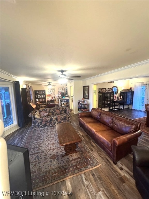 living room with hardwood / wood-style floors, ceiling fan, and crown molding