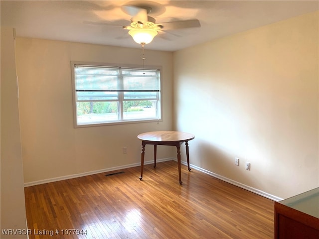 unfurnished room featuring hardwood / wood-style flooring and ceiling fan